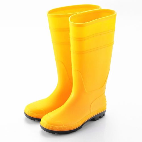 a pair of yellow rubber gumboots with black soles